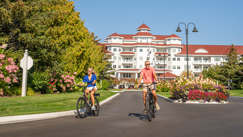 Couple rides electric bikes, Inn at Bay Harbor